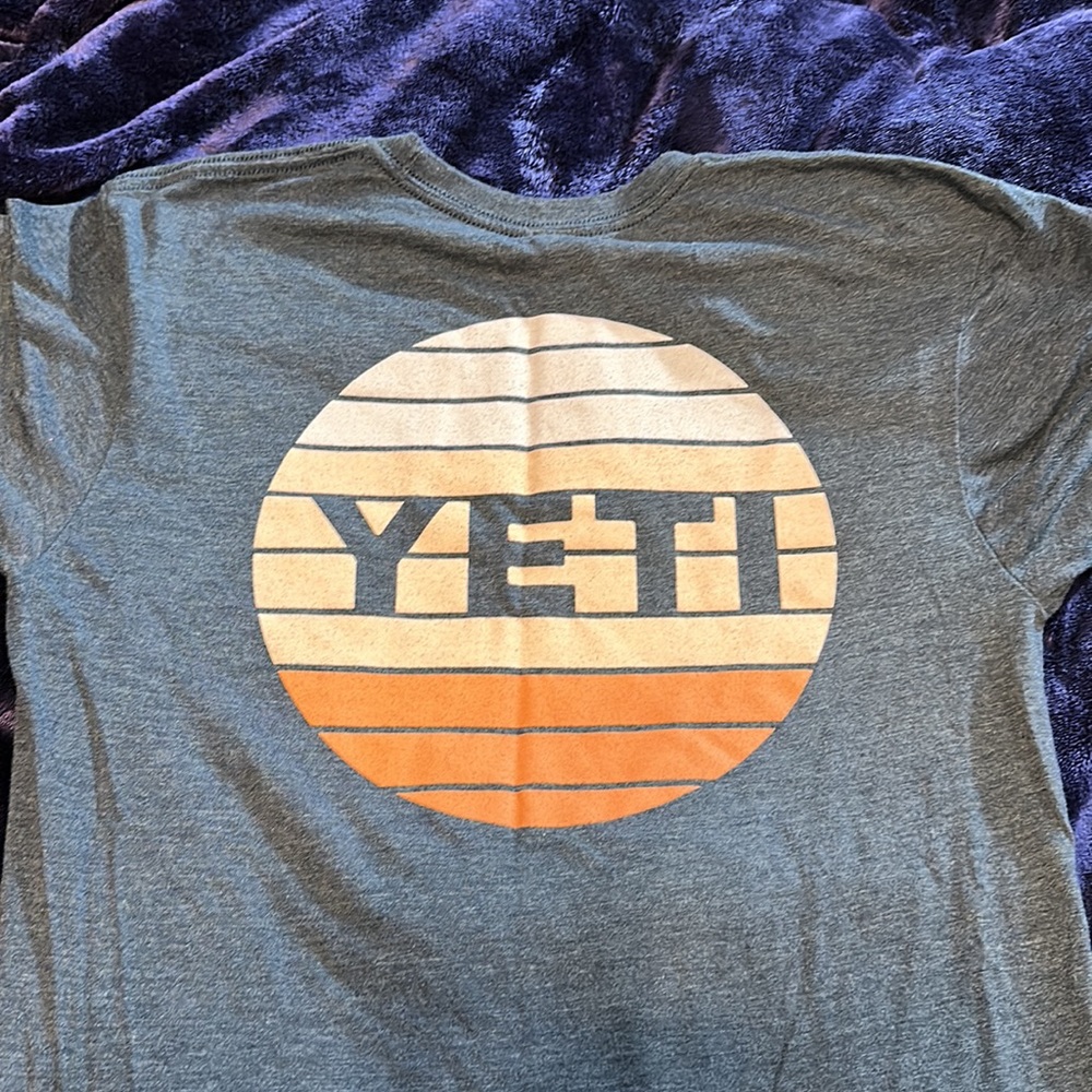 Yeti t-shirt with shades of pink logo on back.